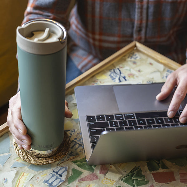 tkwide_20oz_insulated_tumbler_cafe_laptop_closeup_square_600x.jpg