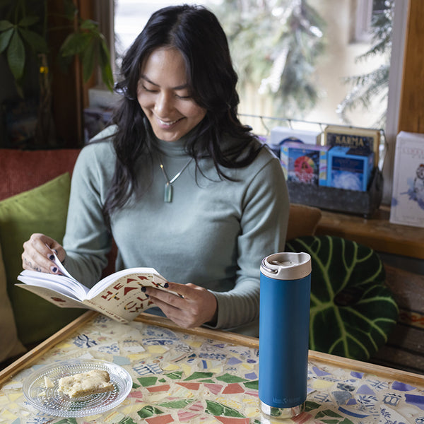 tkwide_20oz_insulated_tumbler_cafe_woman_reading_square_600x.jpg